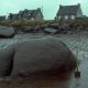 Photo: Large boulder surrounded by a pool of oil.